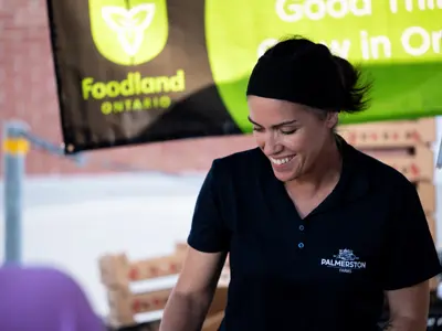 market vendor smiling at booth