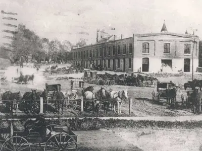 old black and white photo of Kitchener market in 1872 with horse and buggies